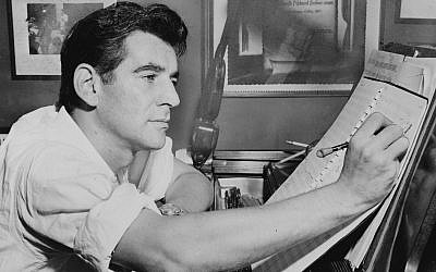 The citation presented to Leonard Bernstein by members of the orchestra in a Displaced Persons camp in Germany after he led them in a concert hangs on the wall in this iconic 1955 image of a young Leonard Bernstein, composing in his studio. (Al Ravenna/Library of Congress)