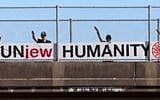 White supremacists hang an anti-Semitic banner on a highway overpass that reads 'UnJew Humanity' (Courtesy: Anti-Defamation League)