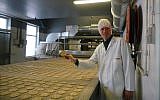 Pieter Heijs shows his product at his Hollandia Matzes factory in Enschede, the Netherlands, March 19, 2018. (Cnaan Liphshiz/JTA)