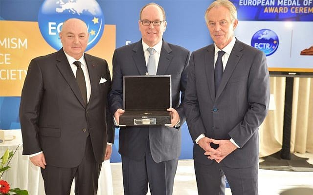 Prince Albert II of Monaco, center, receiving a medal from ECTR President Moshe Kantor, left, and ECTR chair, Tony Blair, on March 6, 2018 in Monte Carlo. Photo: (Courtesy of ECTR via JTA) Prince Albert II of Monaco, center, receiving a medal from ECTR President Moshe Kantor, left, and ECTR chair, Tony Blair, on March 6, 2018 in Monte Carlo. Photo: (Courtesy of ECTR via JTA)