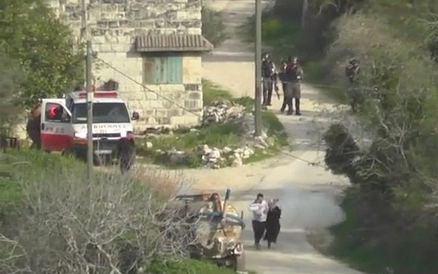 Video from Yesh Din shows a stun grenade thrown by Border Police officers exploding next to a Palestinian couple carrying a baby in the northern West Bank village of Burin on March 2, 2018. (Screen capture: Facebook) Video from Yesh Din shows a stun grenade thrown by Border Police officers exploding next to a Palestinian couple carrying a baby in the northern West Bank village of Burin on March 2, 2018. (Screen capture: Facebook)