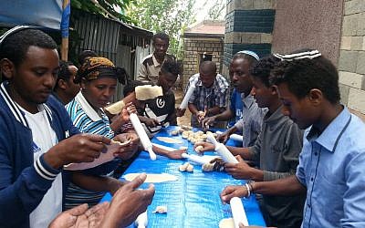 Ethiopian Jews make matzah by hand in the synagogue in Gondar, Ethiopia on March 21, 2018. (courtesy)