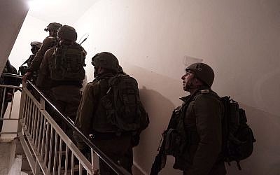 IDF troops prepare the home of Palestinian terrorist Abd al-Rahman Bani Fadel for demolition in the northern West Bank village of Aqraba on March 19, 2018. (Israel Defense Forces)
