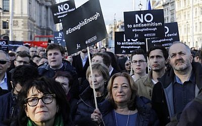 Members of the Jewish community hold a protest against Britain's opposition Labour Party leader Jeremy Corbyn and anti-Semitism in the  Labour party, outside the British Houses of Parliament in central London on March 26, 2018. (AFP/Tolga Akmen)