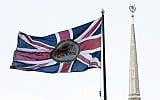 British national flag flutters in front of the British Embassy with the Ukraine Hotel, right, in the background, in Moscow, Russia, Friday, March 16, 2018. (AP Photo/Pavel Golovkin)