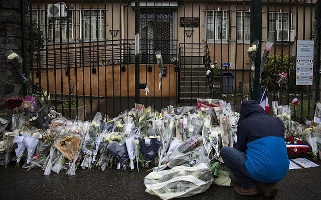 A man places flowers at the main gate of the police headquarters in Carcassonne, France, on Saturday, March 24, 2018, following an attack on a supermarket in the south of France on Friday. (AP Photo/Emilio Morenatti) A man places flowers at the main gate of the police headquarters in Carcassonne, France, on Saturday, March 24, 2018, following an attack on a supermarket in the south of France on Friday. (AP Photo/Emilio Morenatti)