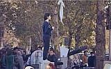 The iconic 'Girl of Enghelab Street,' Vida Movahed, who appeared in public in Tehran, Iran, in December 2017 without wearing a headscarf, as mandated by law. (YouTube screenshot)