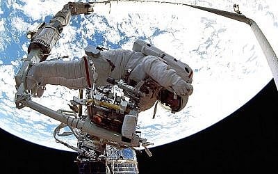 Astronaut Jeffrey Hoffman signaling directions to a European Space Agency astronaut, December 1993. (NASA/Wikimedia Commons public domain via JTA)