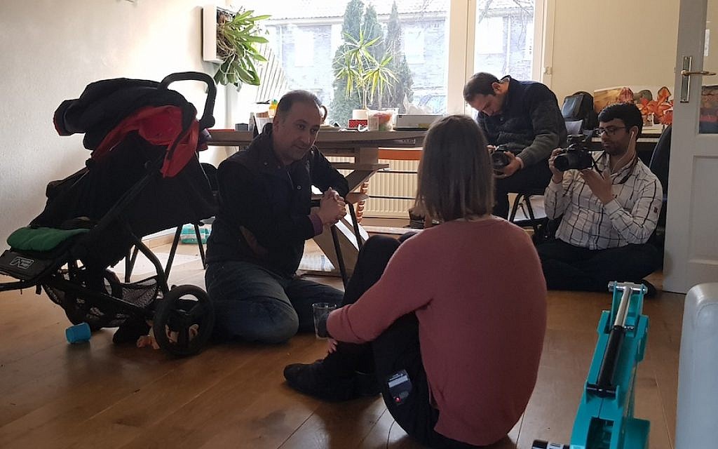 Mohammad Delavari, left, and two members of his filming crew interviewing Iris Tzur at her home in Amsterdam, March 1, 2018. (Cnaan Liphshiz) Mohammad Delavari, left, and two members of his filming crew interviewing Iris Tzur at her home in Amsterdam, March 1, 2018. (Cnaan Liphshiz)