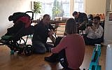 Mohammad Delavari, left, and two members of his filming crew interviewing Iris Tzur at her home in Amsterdam, March 1, 2018. (Cnaan Liphshiz)