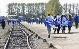 Participants carrying Israeli flags at the former Nazi-German Auschwitz-Birkenau concentration and extermination camp during the 'March of the Living' at Oswiecim in Krakow, Poland on April 24, 2017. (Omar Marques/Anadolu Agency/Getty Images via JTA)