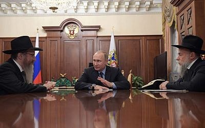 Russian President Vladimir Putin speaks with Russian Chief Rabbi Berel Lazar, left, and Alexander Boroda, head of the Federation of Jewish Communities, during their meeting at the Kremlin in Moscow, December 28, 2016. (Alexei Druzhinin/AFP/Getty Images via JTA)