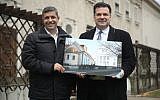 Raed Saleh, left, a Berlin senator, and the city’s Jewish community president, Gideon Joffe, hold an architect’s rendering of a planned reconstruction of the Fraenkelufer Synagogue. (Sean Gallup/Getty Images)