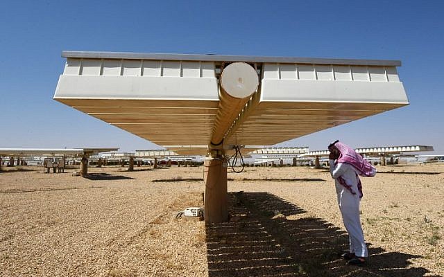 A Saudi man talks on his mobile under the shade of solar panel at a solar plant in Uyayna, north of Riyadh, on March 29, 2018. (FAYEZ NURELDINE/AFP) A Saudi man talks on his mobile under the shade of solar panel at a solar plant in Uyayna, north of Riyadh, on March 29, 2018. (FAYEZ NURELDINE/AFP)