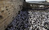 Jews wearing prayer shawls take part in the Kohanim prayer (priest's blessing) during the Passover holiday at the Western Wall in the Old City of Jerusalem, on April 2, 2018. ( AFP PHOTO / MENAHEM KAHANA