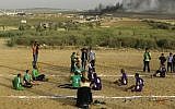 Disabled Palestinians play volleyball near to the site of clashes between Palestinian demonstrators and Israeli security forces following a protest along the Gaza-Israel border, east of Gaza City on April 5, 2018. (AFP/MOHAMMED ABED)