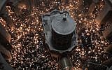Christian Orthodox worshippers hold up candles during the ceremony of the "Holy Fire" as they gather in the Church of the Holy Sepulchre in Jerusalem's Old City, on April 7, 2018, during Orthodox Easter ceremonies.(AFP PHOTO / MENAHEM KAHANA)