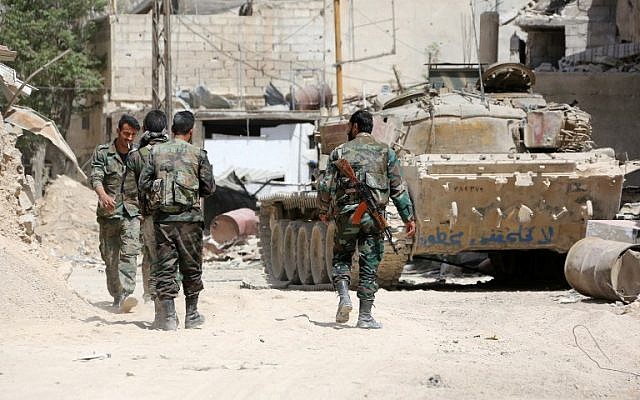 A picture taken on April 8, 2018, shows Syrian Army soldiers gathering in an area on the eastern outskirts of Douma, as they continue their offensive to retake the last opposition holdout in Eastern Ghouta. (AFP Photo/Stringer) A picture taken on April 8, 2018, shows Syrian Army soldiers gathering in an area on the eastern outskirts of Douma, as they continue their offensive to retake the last opposition holdout in Eastern Ghouta. (AFP Photo/Stringer)