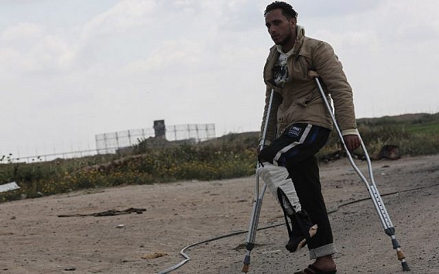Tamer Abu Daqqa, a Palestinian who says he was shot by an Israeli sniper along the Gaza border during a protest, walks with crutches near the Gaza-Israel border near Khan Yunis in the southern Gaza Strip on April 11, 2018. (AFP PHOTO/SAID KHATIB) Tamer Abu Daqqa, a Palestinian who says he was shot by an Israeli sniper along the Gaza border during a protest, walks with crutches near the Gaza-Israel border near Khan Yunis in the southern Gaza Strip on April 11, 2018. (AFP PHOTO/SAID KHATIB)