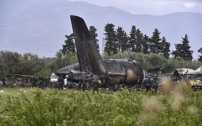 Rescuers are seen around the wreckage of an Algerian plane which crashed near the Boufarik airbase from where the plane had taken off on April 11, 2018. The military plane crashed and caught fire killing 257 people, mostly army personnel and members of their families, officials said (Ryad Kramdi/AFP Photo)