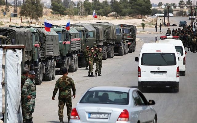 Syrian and Russian soldiers at the entrance of the Wafideen Camp in Syria, on April 12, 2018. (AFP Photo/Youssef Karwashan) Syrian and Russian soldiers at the entrance of the Wafideen Camp in Syria, on April 12, 2018. (AFP Photo/Youssef Karwashan)