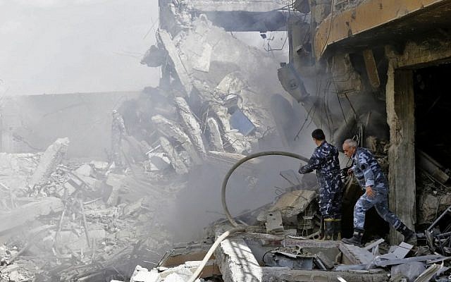 Syrian soldiers inspect the wreckage of a building described as part of the Scientific Studies and Research Center (SSRC) compound in the Barzeh district, north of Damascus, during a press tour organised by the Syrian information ministry, on April 14, 2018. (AFP / LOUAI BESHARA) Syrian soldiers inspect the wreckage of a building described as part of the Scientific Studies and Research Center (SSRC) compound in the Barzeh district, north of Damascus, during a press tour organised by the Syrian information ministry, on April 14, 2018. (AFP / LOUAI BESHARA)