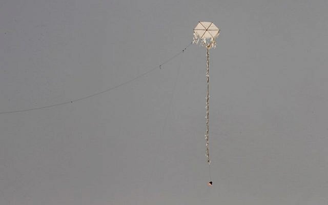 A kite with a firebomb attached to it is flown by Palestinian protestors towards the border fence with Israel, in Rafah in the southern Gaza Strip, on April 20, 2018. (AFP Photo/Said Khatib)