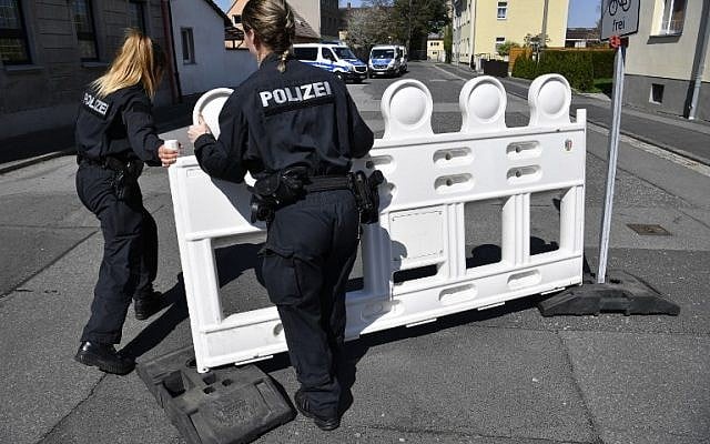German policewomen fence off an area on April 20, 2018, as part of the security measures ahead of the "Schild und Schwert" (Shield and Sword, or SS) neo-nazi festival, in the small eastern German town of Ostritz. ( AFP PHOTO/John MACDOUGALL) German policewomen fence off an area on April 20, 2018, as part of the security measures ahead of the "Schild und Schwert" (Shield and Sword, or SS) neo-nazi festival, in the small eastern German town of Ostritz. ( AFP PHOTO/John MACDOUGALL)