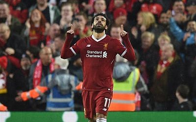 Liverpool's Egyptian midfielder Mohamed Salah celebrates scoring their first goal during the UEFA Champions League first leg semi-final football match between Liverpool and Roma at Anfield stadium in Liverpool, north west England on April 24, 2018. (AFP PHOTO / Oli SCARFF)
