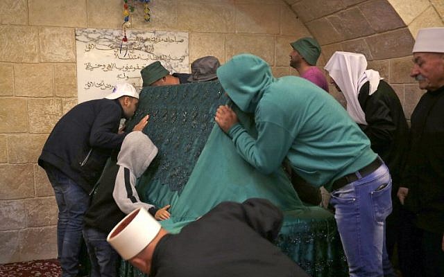 Members of Israel's Druze community kiss the holy tomb of Nebi Shu’eib during a celebration in northern Israel on April 25, 2018. (AFP Photo Jalaa/Marey)