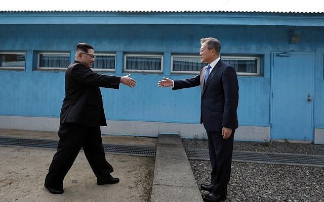 North Korea's leader Kim Jong Un (L) shakes hands with South Korea's President Moon Jae-in (R) at the Military Demarcation Line that divides their countries ahead of their summit at the truce village of Panmunjom on April 27, 2018.(AFP PHOTO / Korea Summit Press Pool / Korea Summit Press Pool) North Korea's leader Kim Jong Un (L) shakes hands with South Korea's President Moon Jae-in (R) at the Military Demarcation Line that divides their countries ahead of their summit at the truce village of Panmunjom on April 27, 2018.(AFP PHOTO / Korea Summit Press Pool / Korea Summit Press Pool)