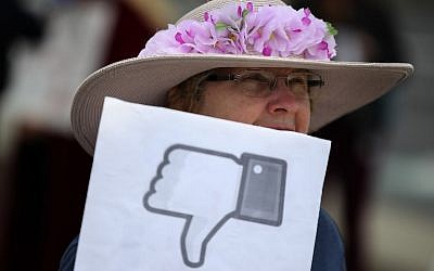 A protester with the group 'Raging Grannies' holds a sign during a demonstration outside of Facebook headquarters on April 5, 2018 in Menlo Park, California. (Justin Sullivan/Getty Images/AFP)