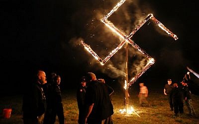 Illustrative: Members of the National Socialist Movement, one of the largest neo-Nazi groups in the US, hold a swastika burning after a rally on April 21, 2018 in Draketown, Georgia. (Spencer Platt/Getty Images/AFP)