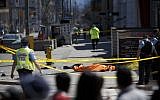 A tarp lays on top of a body on Yonge St. at Finch Ave. after a van plowed into pedestrians on April 23, 2018 in Toronto, Canada. A suspect is in custody after a white van collided with multiple pedestrians.   (Cole Burston/Getty Images/AFP)