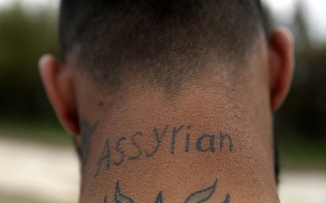 In this April 1, 2018 photo, an Assyrian Christian militiaman guards a park where his community is celebrating Easter and the Assyrian New Year, or Akitu, in the village of Tal Arboush, northern Syria. They were snatching joy out of a sober surrounding. (AP Photo/Hussein Malla) In this April 1, 2018 photo, an Assyrian Christian militiaman guards a park where his community is celebrating Easter and the Assyrian New Year, or Akitu, in the village of Tal Arboush, northern Syria. They were snatching joy out of a sober surrounding. (AP Photo/Hussein Malla)