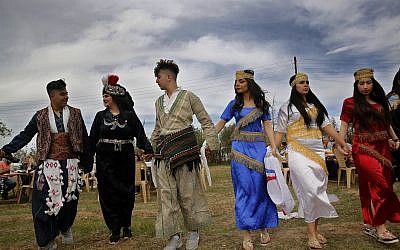 In this April 1, 2018 photo, Assyrian Christian dancers wear their traditional costumes, as they celebrate Easter and the Assyrian New Year, or Akitu, in the village of Tal Arboush, northern Syria. They were snatching joy out of a sober surrounding. (AP Photo/Hussein Malla)