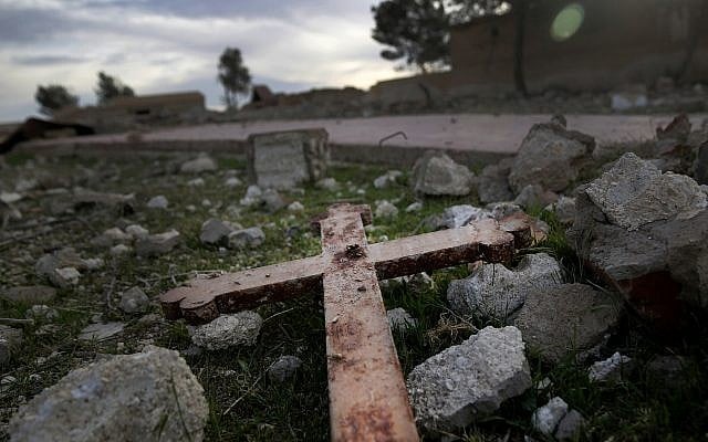 In this photo from April 1, 2018, a cross lies in the rubble of a destroyed church that was blown up by Islamic State militants in 2015, in the deserted village of Tal Jazeera, northern Syria. (AP Photo/Hussein Malla) In this photo from April 1, 2018, a cross lies in the rubble of a destroyed church that was blown up by Islamic State militants in 2015, in the deserted village of Tal Jazeera, northern Syria. (AP Photo/Hussein Malla)