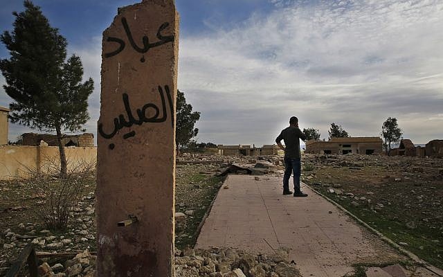 In this April 1, 2018 photo, Zaya Youkhana, an Assyrian Christian stands on the rubble of a destroyed church that was blown up by Islamic State militants in 2015, in the deserted village of Tal Jazeera, northern Syria. (AP Photo/Hussein Malla) In this April 1, 2018 photo, Zaya Youkhana, an Assyrian Christian stands on the rubble of a destroyed church that was blown up by Islamic State militants in 2015, in the deserted village of Tal Jazeera, northern Syria. (AP Photo/Hussein Malla)