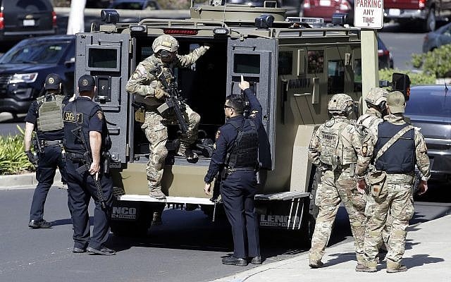 Armed law enforcement personnel exit an armored vehicle outside YouTube headquarters, in San Bruno, California, April 3, 2018. (Marcio Jose Sanchez/AP) Armed law enforcement personnel exit an armored vehicle outside YouTube headquarters, in San Bruno, California, April 3, 2018. (Marcio Jose Sanchez/AP)