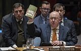 Russian Ambassador to the United Nations Vassily Nebenzia holds up a copy of 'Alice's Adventures in Wonderland' as he speaks during a Security Council meeting on the situation between Britain and Russia on April 5, 2018 at United Nations headquarters in New York. (AP Photo/Mary Altaffer)