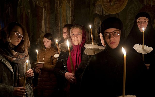 Kosovo Serb Orthodox pilgrims hold candles during an Easter vigil mass in the monastery of Gracanica during an Easter service, Kosovo, April 8, 2018. (AP Photo/Visar Kryeziu)
