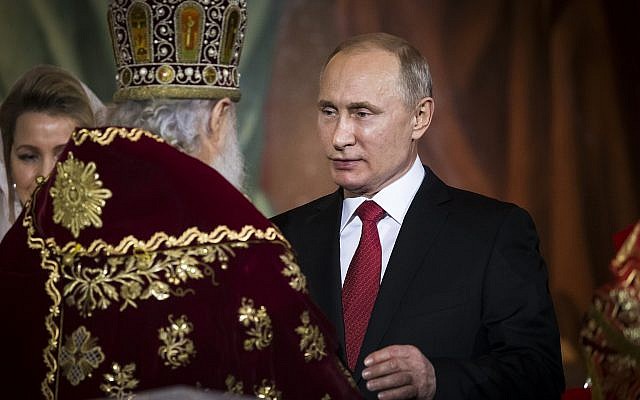 Russian Orthodox Patriarch Kirill, left, greets Russian President Vladimir Putin, right, during the Easter service in the Christ the Savior Cathedral in Moscow, Russia, April 8, 2018. (AP Photo/Alexander Zemlianichenko, Pool)