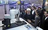 President Hassan Rouhani listens to explanations on new nuclear achievements at a ceremony to mark 'National Nuclear Day,' in Tehran, Iran, April 9, 2018.  (Iranian Presidency Office via AP)