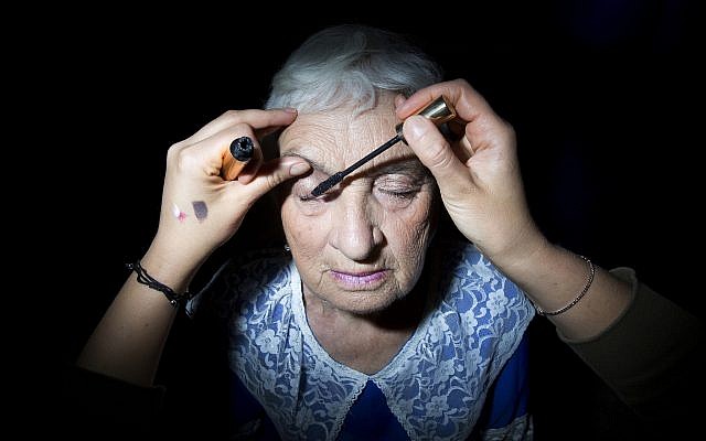 Holocaust survivor Elizabeth Rudich, 86, gets her makeup ready during a Beauty Heroines event in Ramat Gan, Israel, Monday, April 9, 2018. (AP Photo/Oded Balilty)
