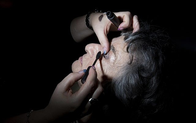Holocaust survivor Rosie Mordo, 85, gets her makeup ready during a Beauty Heroines event in Ramat Gan, Israel, Monday, April 9, 2018. (AP Photo/Oded Balilty)