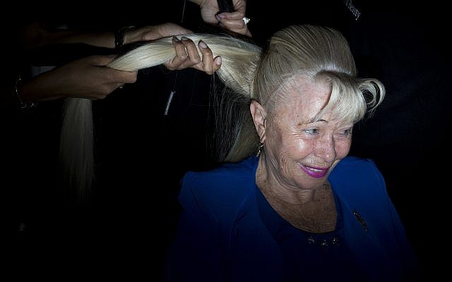 Holocaust survivor Dvorah Weinstein, 80, gets her hair done during a Beauty Heroines event in Ramat Gan, Israel, Monday, April 9, 2018. (AP Photo/Oded Balilty)