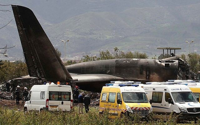 Firefighters and civil security officers work at the scene of a fatal military plane crash in Boufarik, near the Algerian capital, Algiers, on April 11, 2018. (AP Photo/Anis Belghoul)