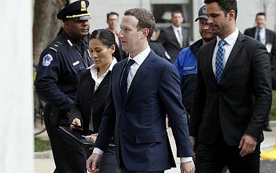 Facebook CEO Mark Zuckerberg, center, arrives to testify before a House Energy and Commerce hearing on Capitol Hill in Washington on April 11, 2018, about the use of Facebook data to target American voters in the 2016 election. (AP Photo/Alex Brandon)