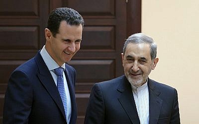 Syrian president Bashar Assad, left, meets with Ali Akbar Velayati, a top foreign policy adviser to Iran's Supreme Leader Ali Khamenei, in Damascus, Syria, April 12, 2018. (SANA via AP)
