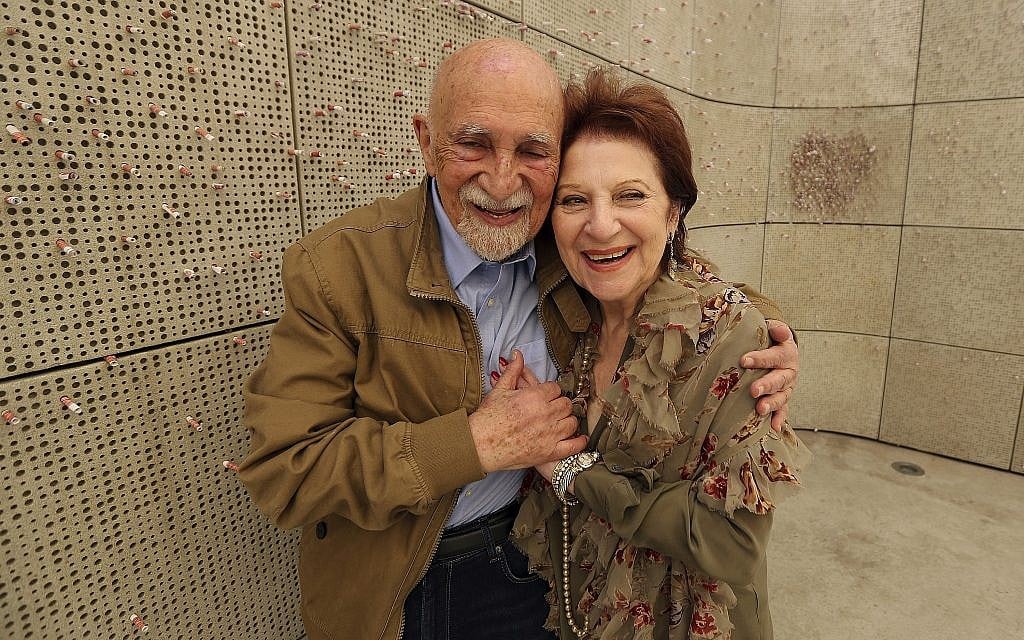 In this Wednesday, April 11, 2018, photo, childhood Holocaust survivors Simon Gronowski and Alice Gerstel Weit hug at the Los Angeles Holocaust Museum memorial. (AP Photo/Reed Saxon)